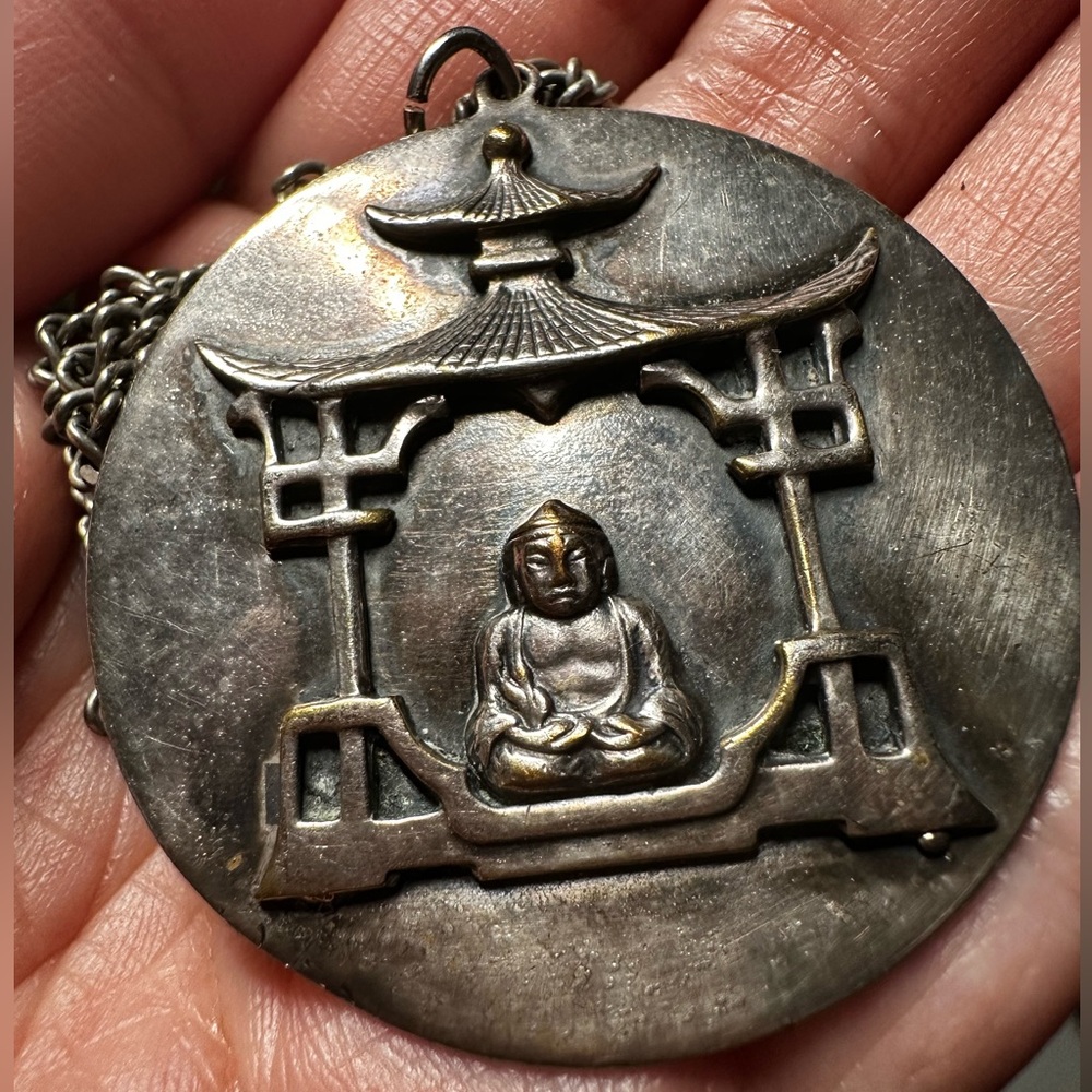 Vintage Big Pendant with Buddha Design on a shrine